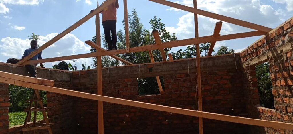 Workers constructing the wooden roof frame