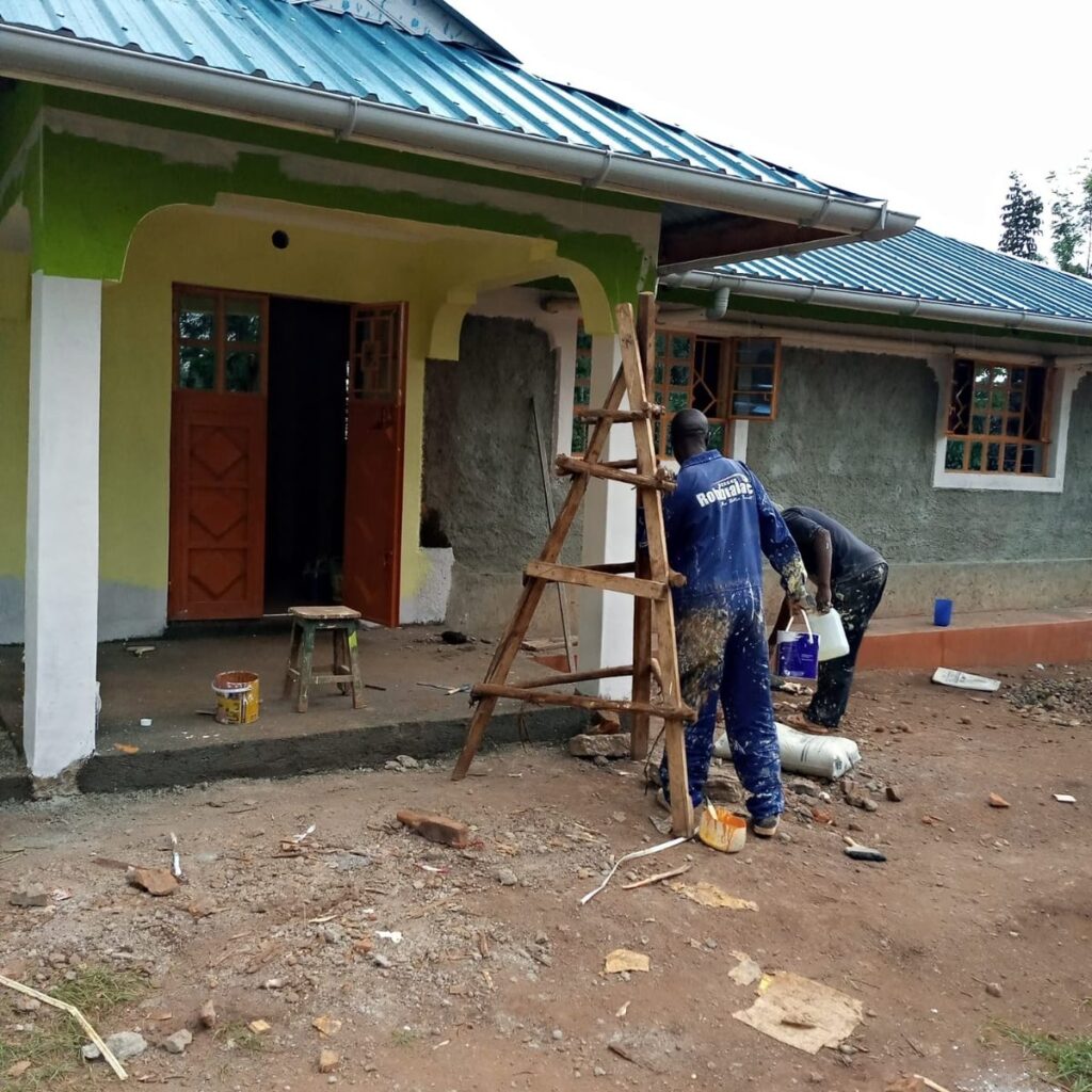 Workers painting and completing exterior finishes