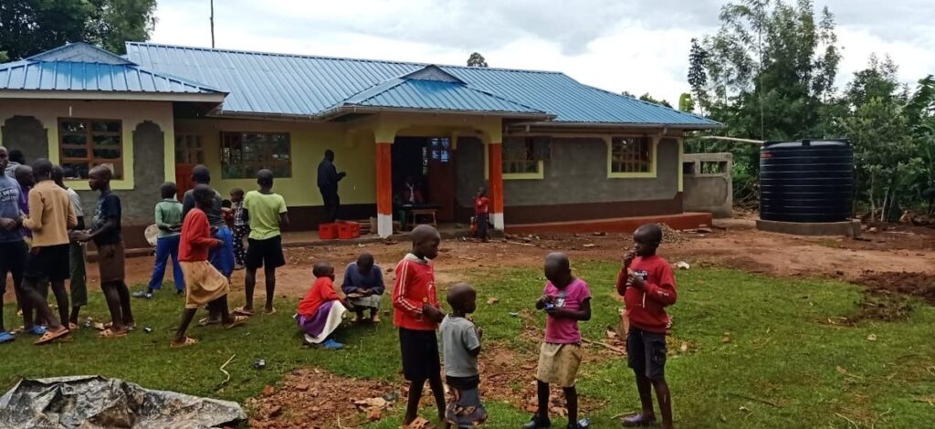 Children gathered outside the completed orphanage home