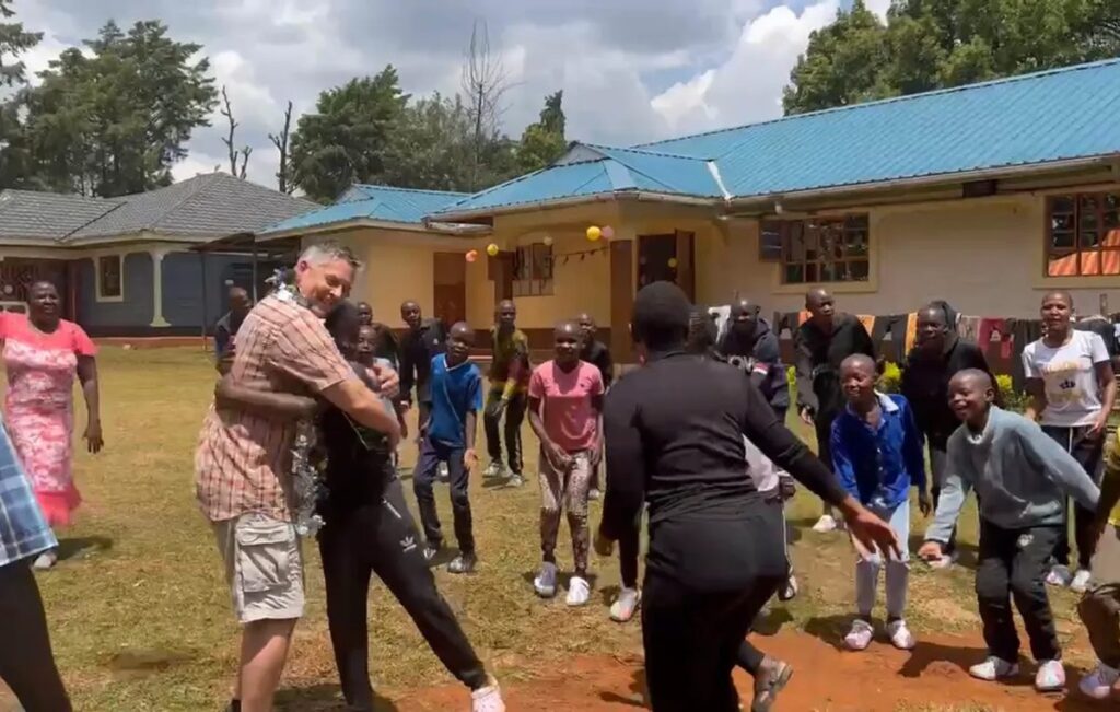 Children celebrating together outside the orphanage home