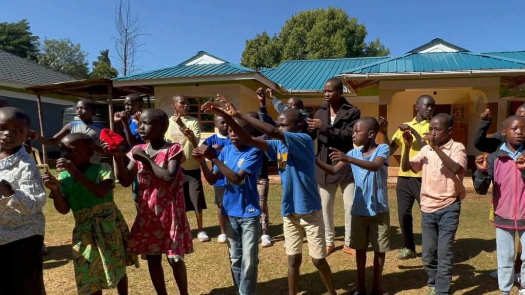 Children celebrating together on the grounds of the orphanage