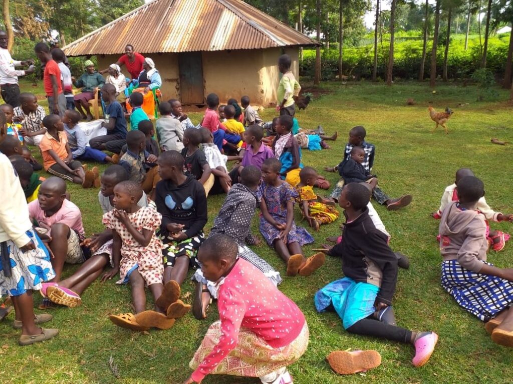 Children gathered near the original shelter